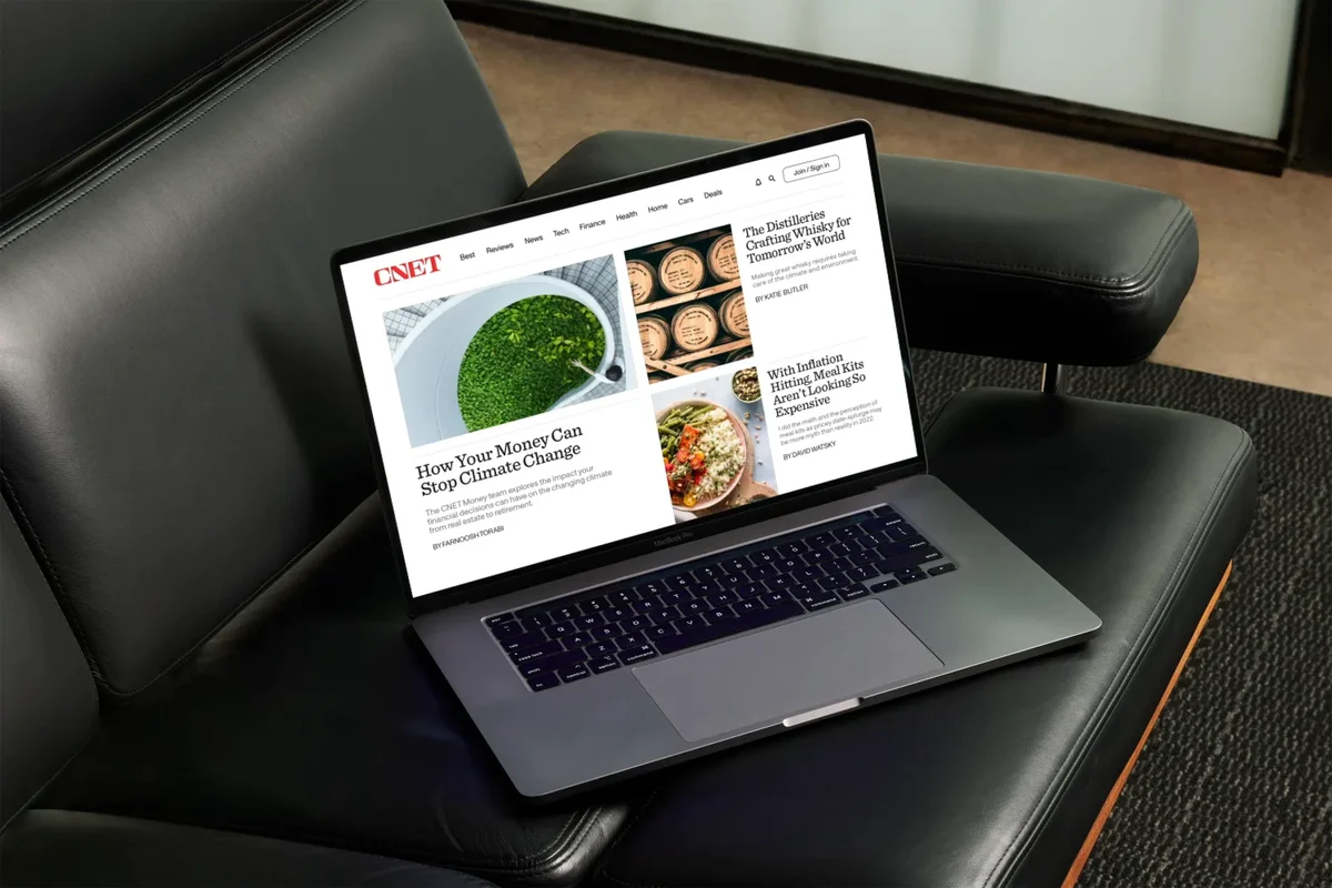 CNET site on a laptop in a leather chair