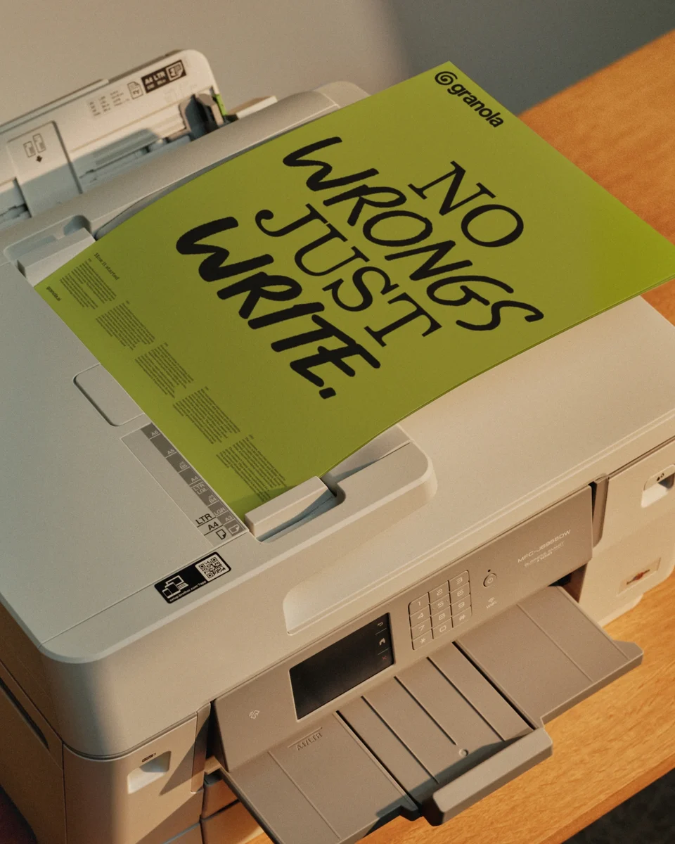 Printed Granola notebook in lime green on a desk