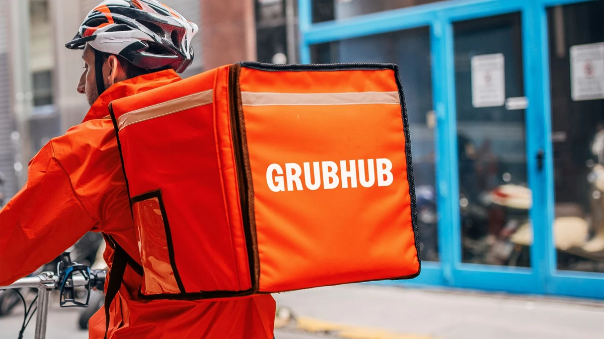 Grubhub courier with an orange delivery bag