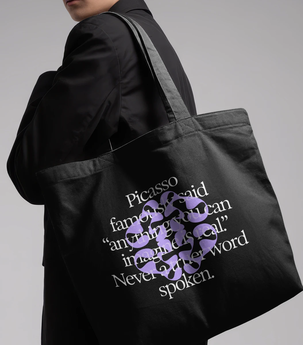 Black tote bag printed with Ideogram graphics in purple
