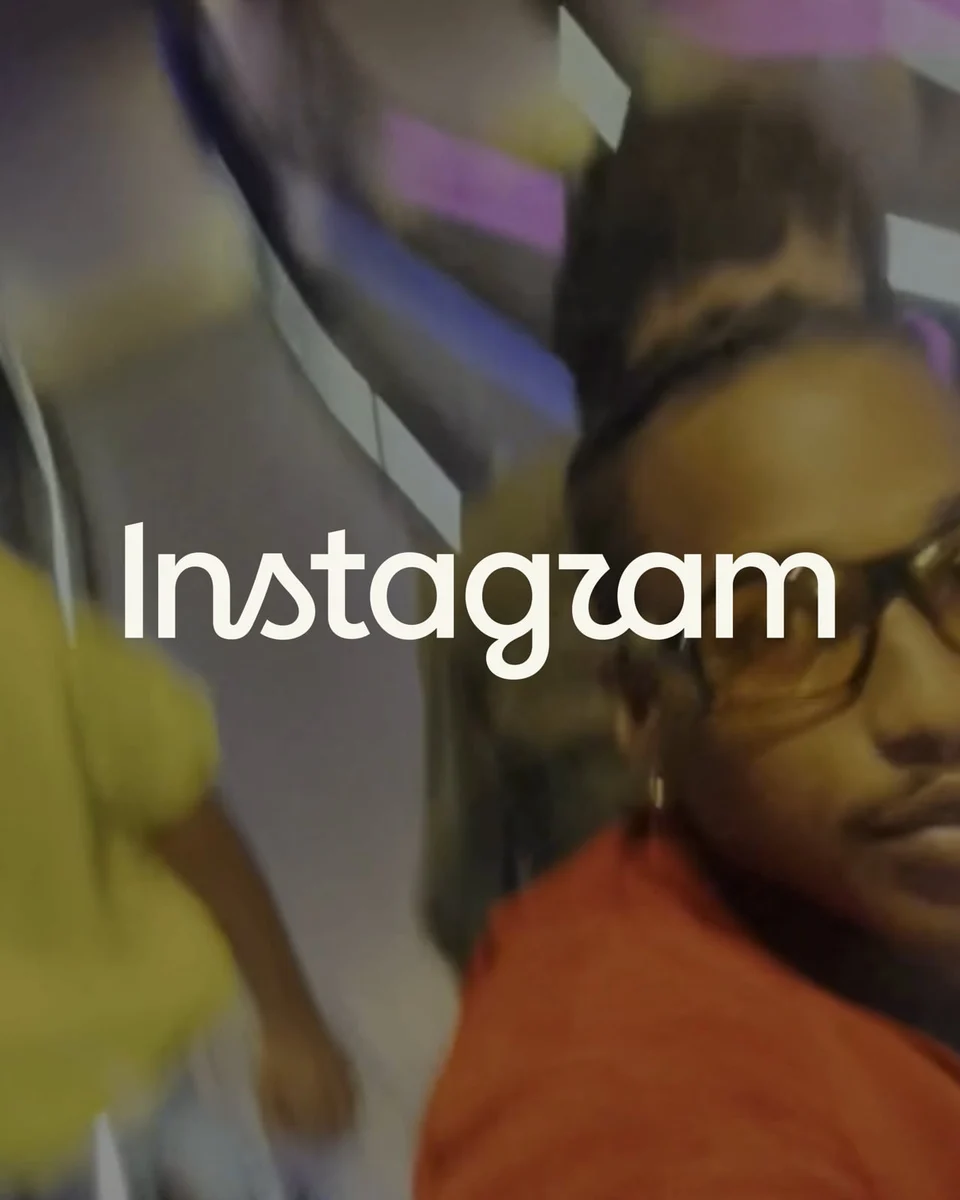 White Instagram wordmark over a blurred street photo