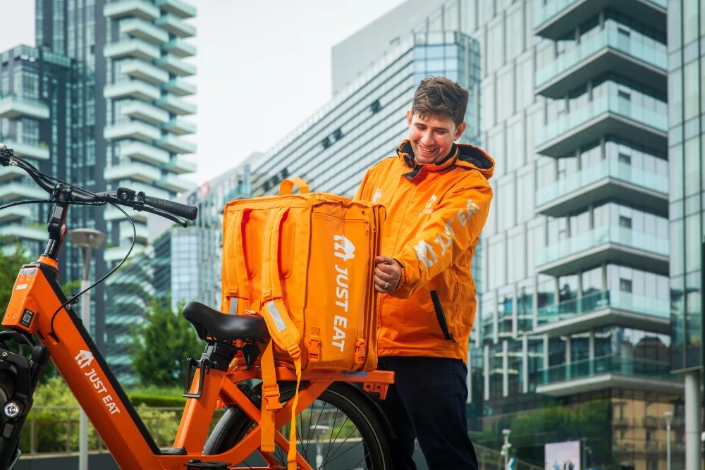 Just Eat courier on an orange cargo bike