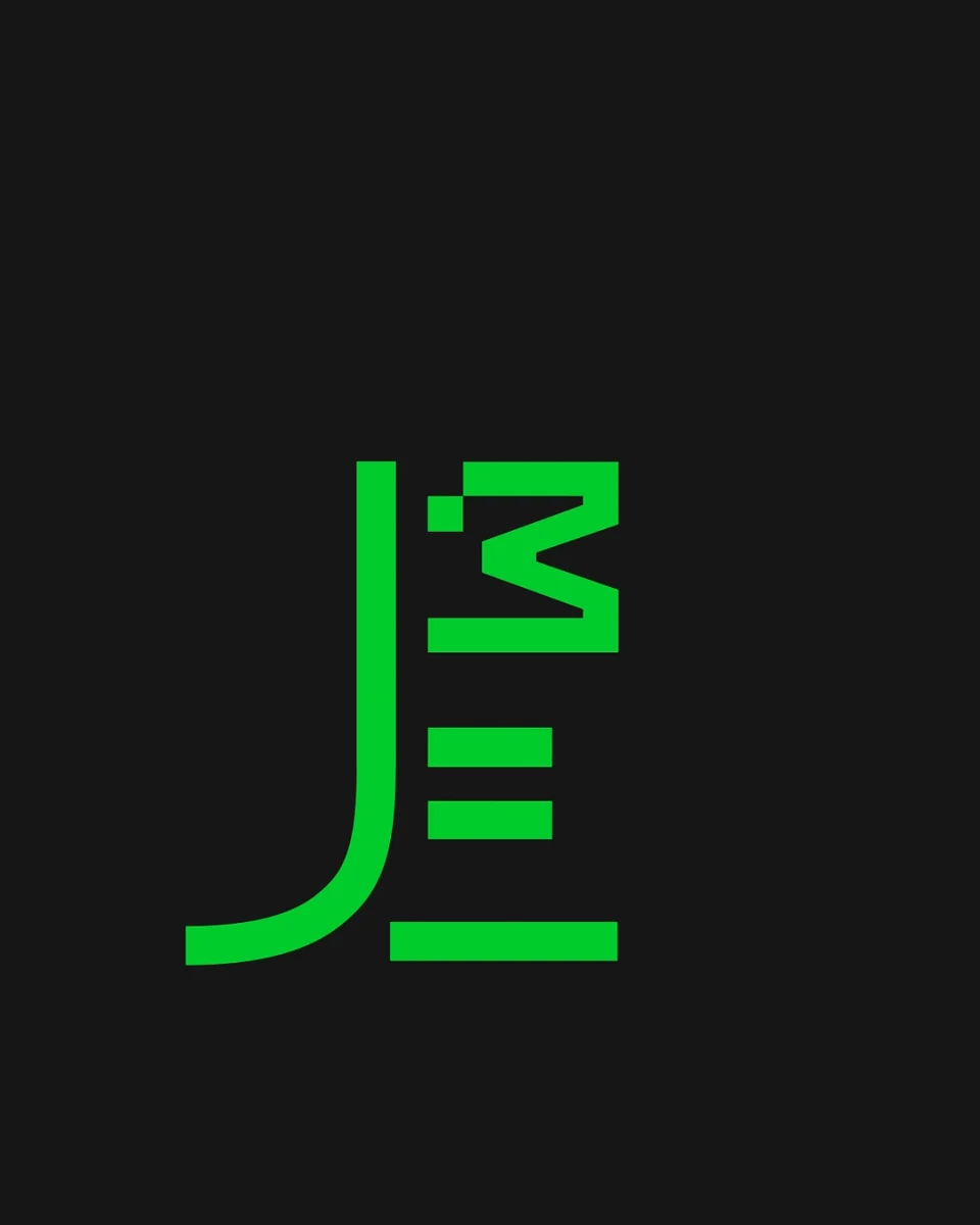 A stylized green flag logo on a black background, featuring bold geometric lines and sharp angles, creating a modern and dynamic visual impression.
