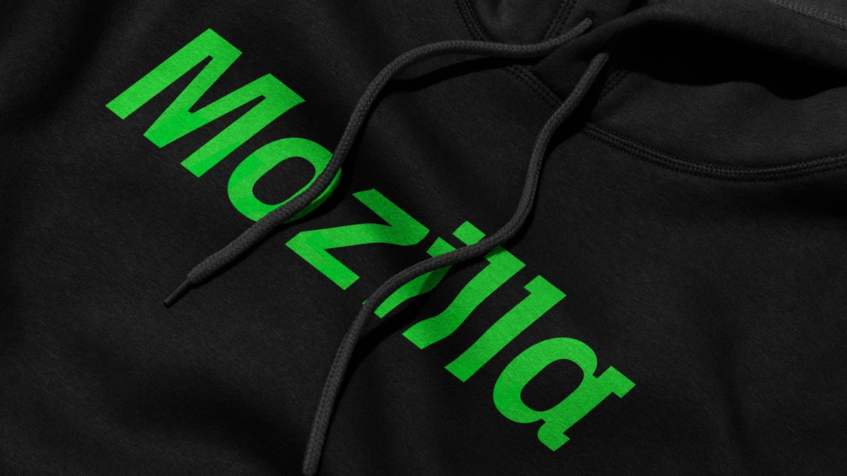 Green Mozilla wordmark printed large across a black hoodie