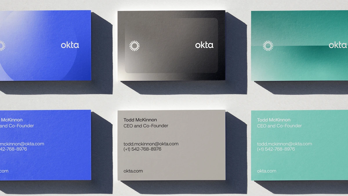 Okta business cards in blue, grey and teal