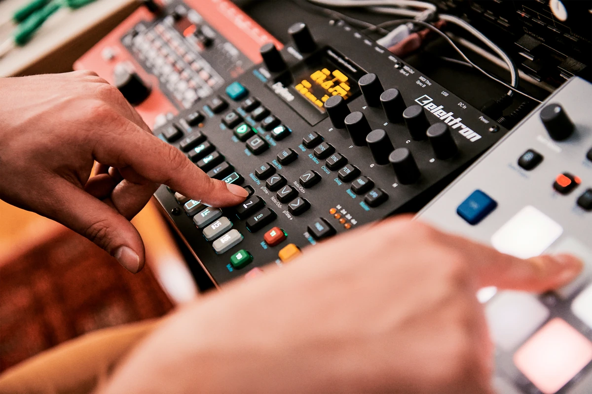 Hands working a music sampler, Patreon brand photography