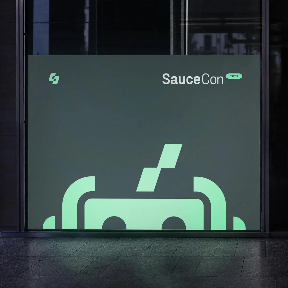 SauceCon signage with the pixel bot mark on dark green
