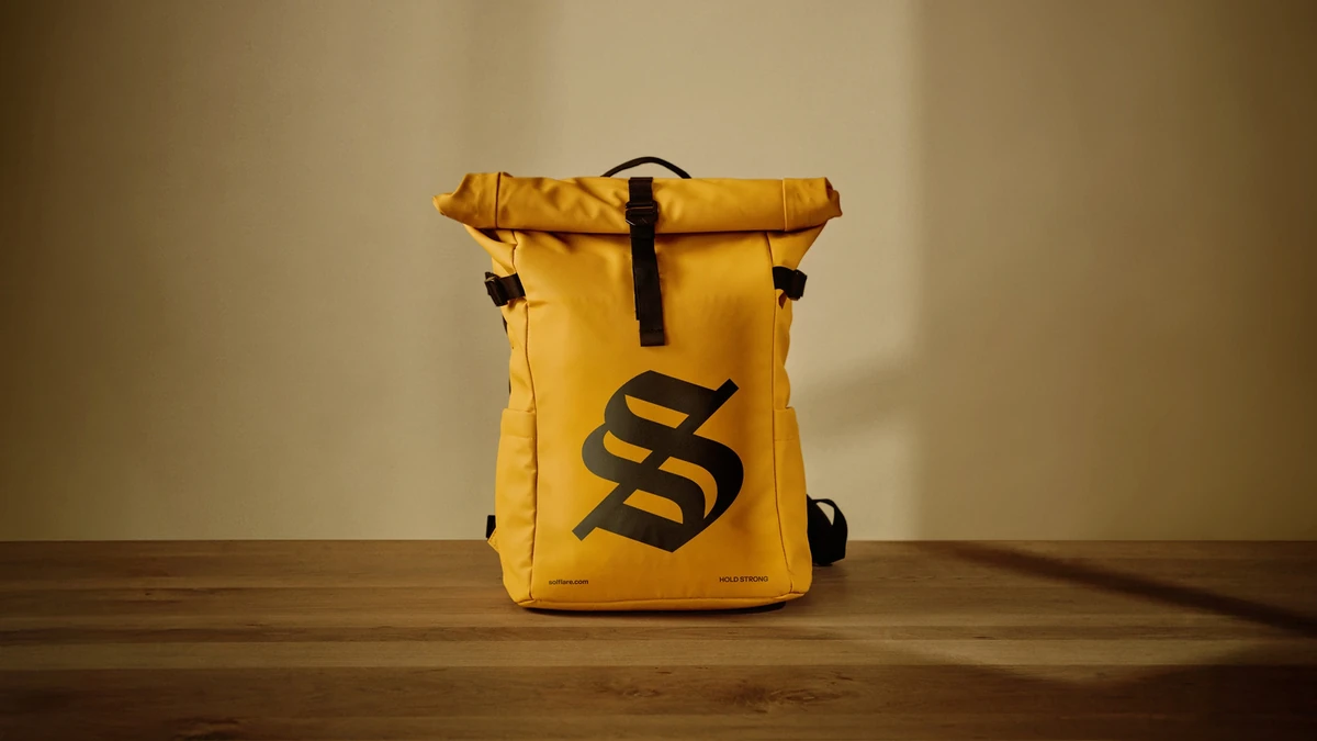 Yellow Solflare backpack on a wooden bench
