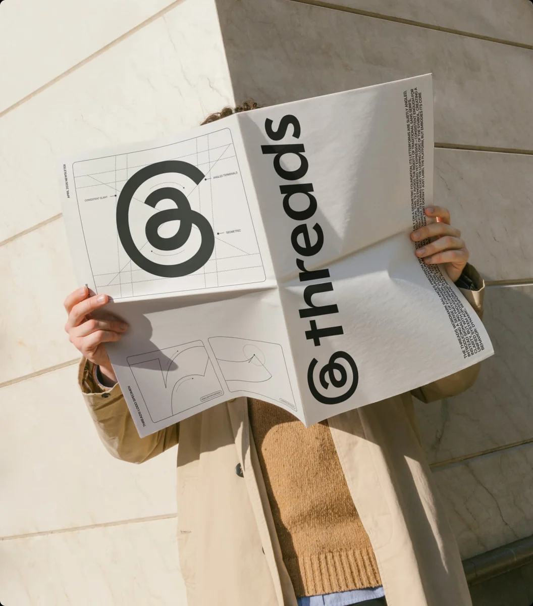 Person holding a printed Threads tote bag