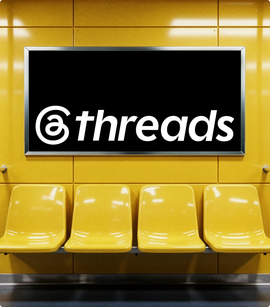 Threads logo sign above yellow subway seats