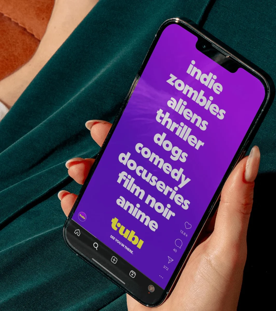 Tubi app on a phone with a pink screen