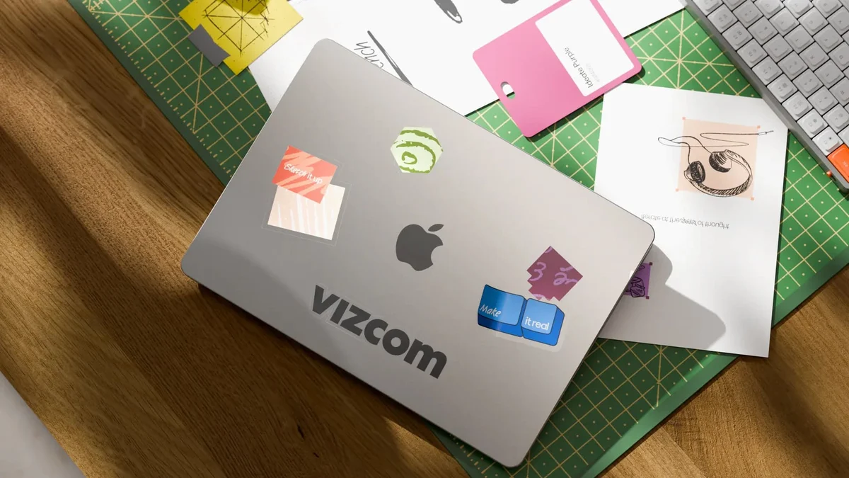 Vizcom-branded laptop stickers and stationery on a desk