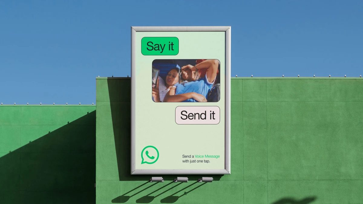 WhatsApp poster on a green building: 'Say it / Send it'