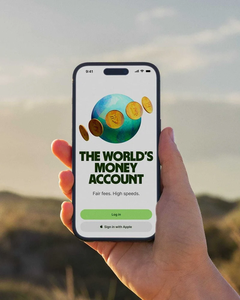 Phone showing a Wise 'The world's money account' screen at sunset
