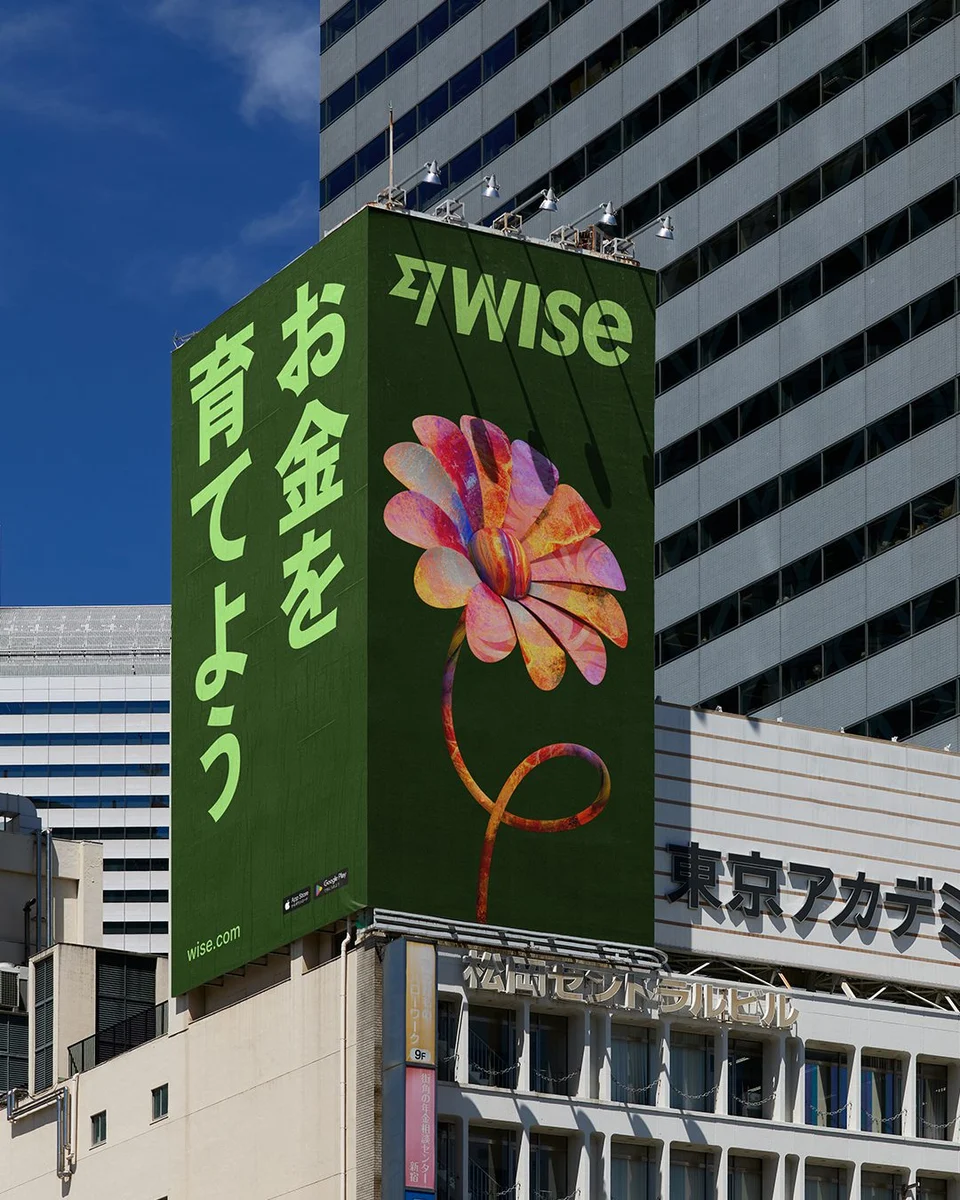 Wise billboard with a flower artwork among city buildings