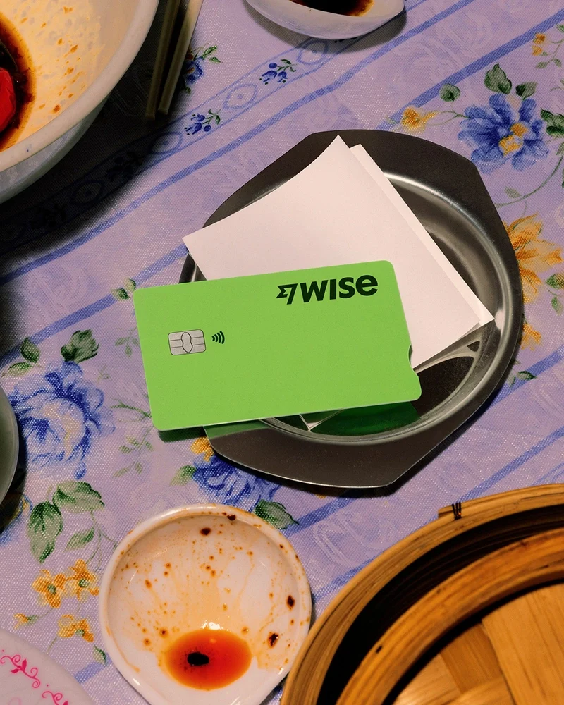 Green Wise card on a plate with a floral tablecloth