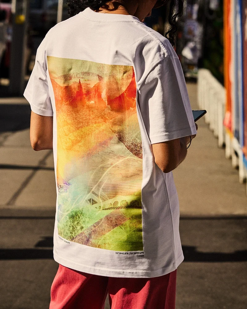 Back of a T-shirt with a colourful painted Wise artwork