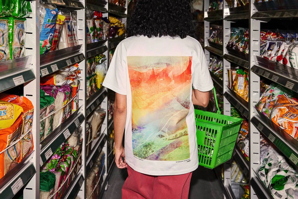Shopper in a supermarket wearing a Wise T-shirt with colourful artwork